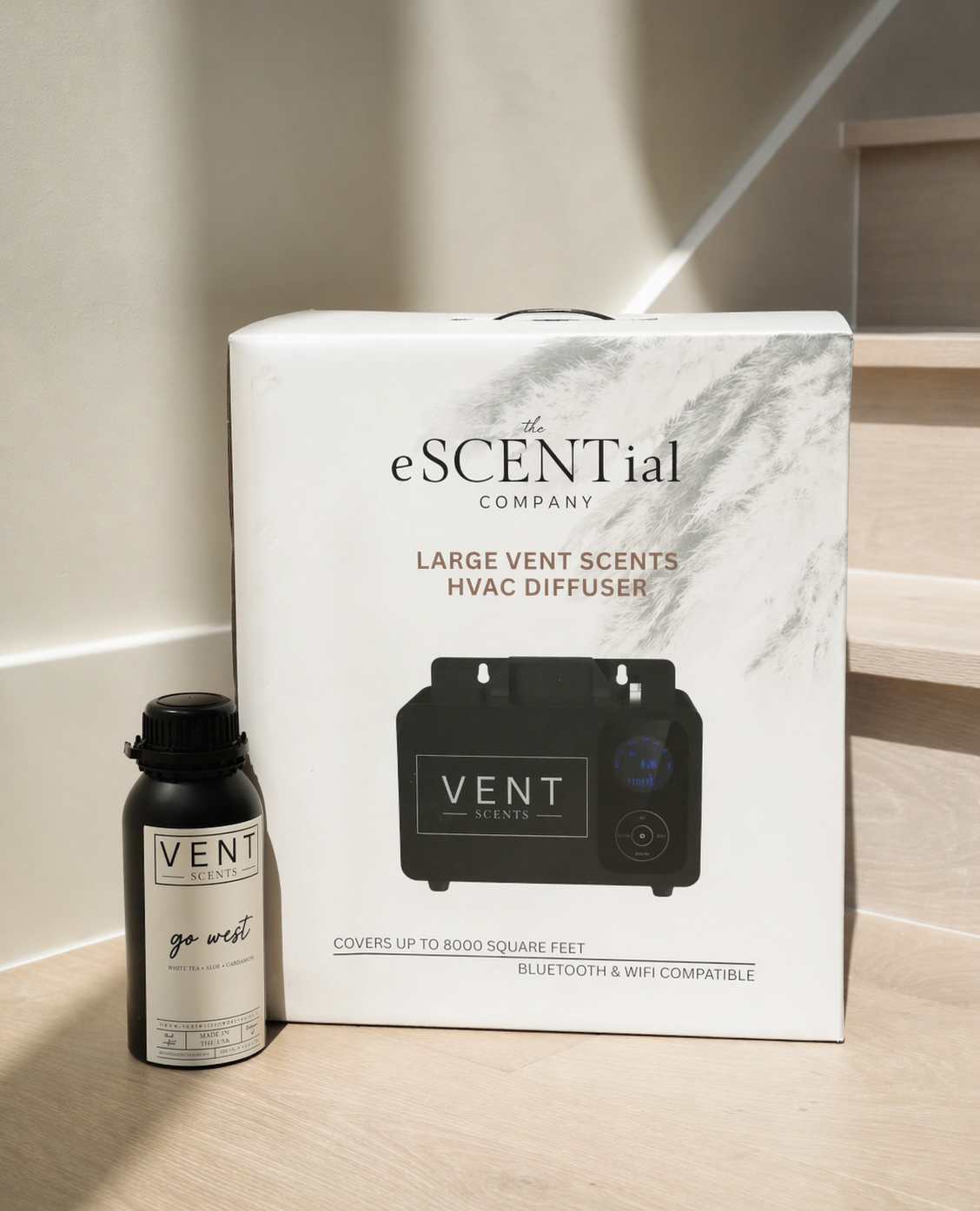 eSCENTial Company Vent Scents HVAC diffuser packaging with diffuser bottle on a light wooden floor.